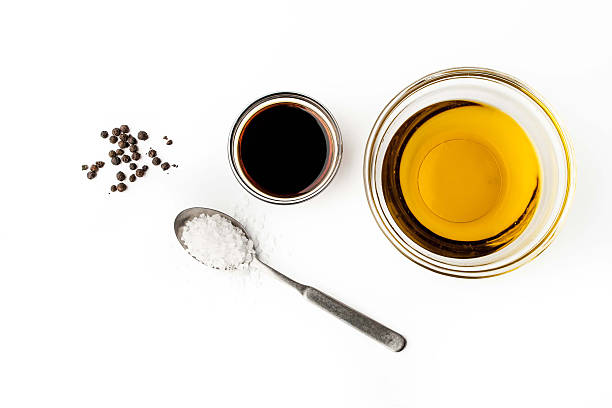 Olive oil with seasoning on the white background top view