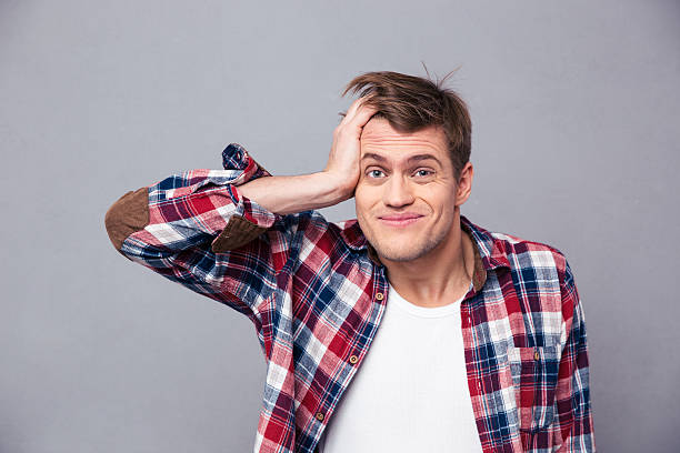 istock Close up of embarrassed man scratching head and looking confused 504306586