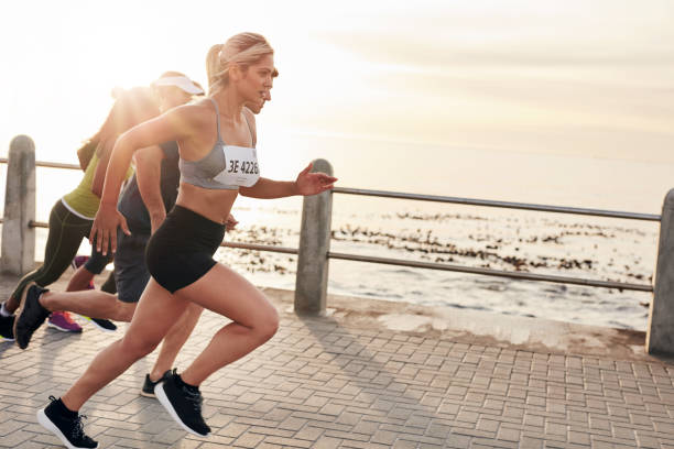 istock Young people running on seaside promenade 504311044