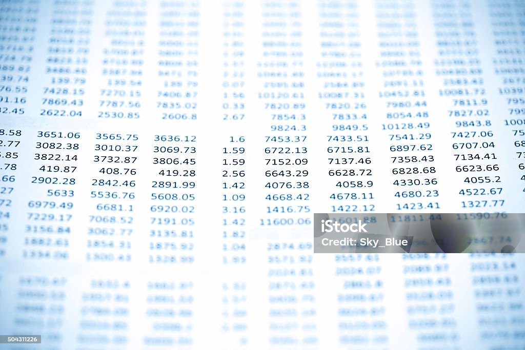 Rows of numbers Blue tone macro picture of numbers on a data printout paper with selective focus. Financial Figures Stock Photo