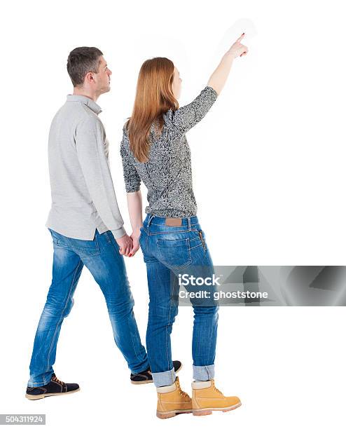 Back View Of Walking Young Couple Stock Photo - Download Image Now - Couple - Relationship, Walking, Pointing