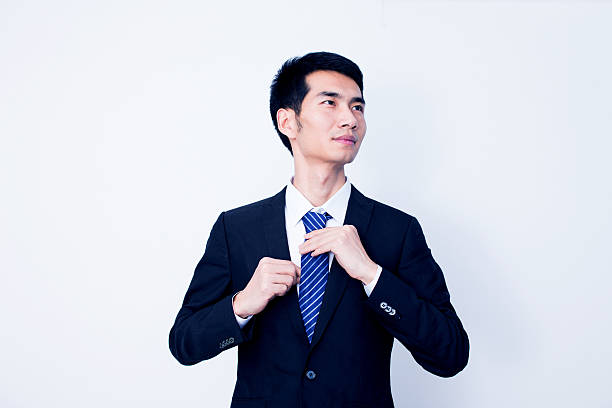 Businessman fixing his tie
