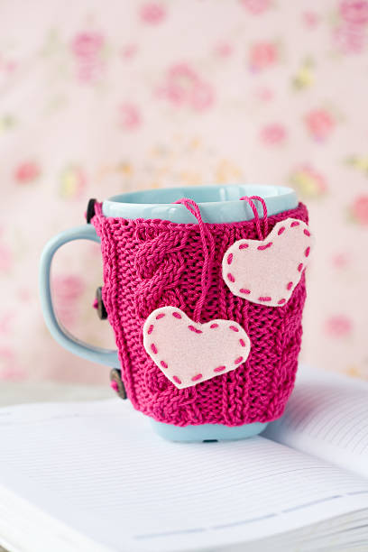 istock Blue cup in a pink sweater with felt hearts 504313200