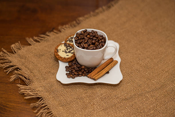 istock coffee beans cinnamon cookie white cup and saucer 504313242