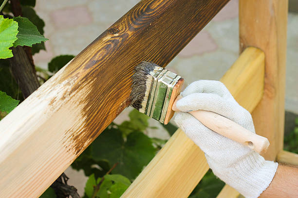 istock man covered with lacquer wooden fence 504313527