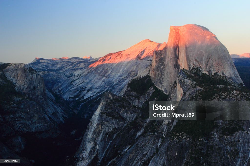High Country Sunset Alpine glow casted on the Northwest face of Half Dome.   Cliff Stock Photo