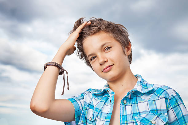 Teenage boy sitting in park