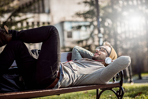 istock handsome man relaxing in the park 504316328