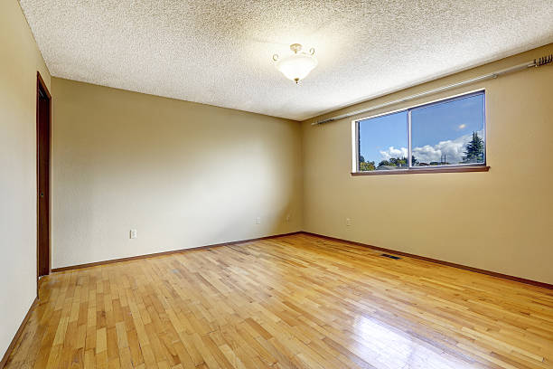 istock Empty room with window and hardwood floor 504316993
