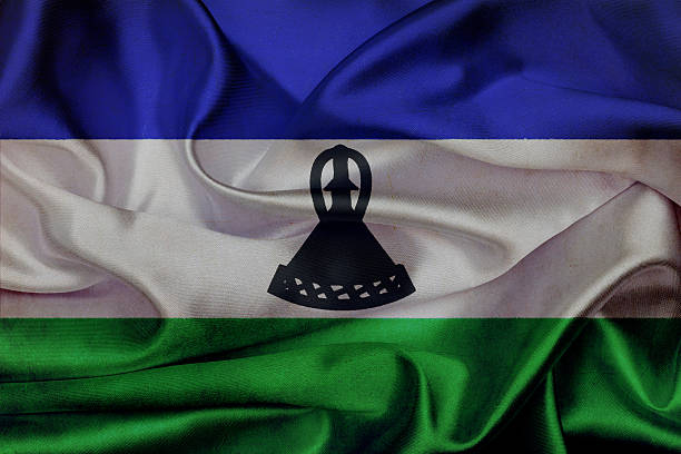 nice glossy flag of Lesotho with large folds lying flat isolated on white, perspective view - any holiday flag 3d illustration