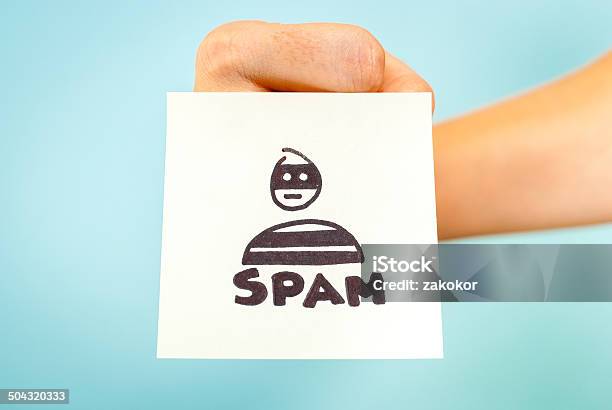 Fist With Email Spam Word Note Blue Background Stock Photo - Download Image Now - Social Media, Abuse, Advertisement