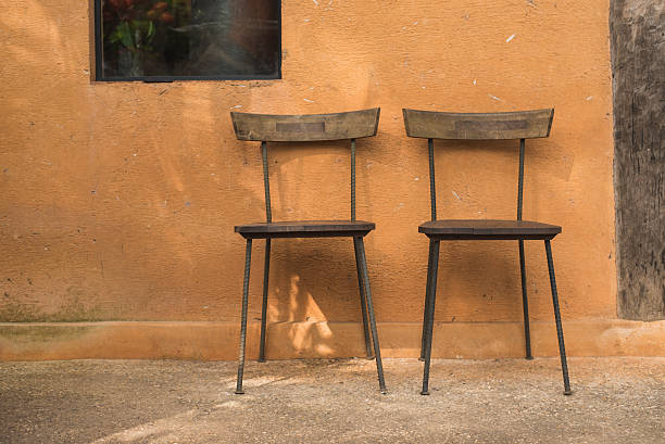 istock wooden chair and brown wall 504328330