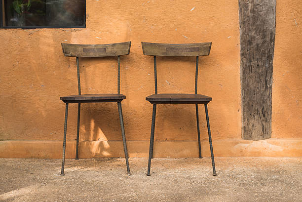 istock wooden chair and brown wall 504328556