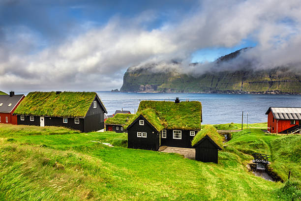 Village of Mikladalur, Faroe Islands, Denmark Village of Mikladalur located on the island of Kalsoy, Faroe Islands, Denmark faroe islands photos stock pictures, royalty-free photos & images