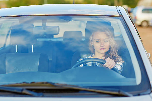 istock Young confident woman driving a car 504329560