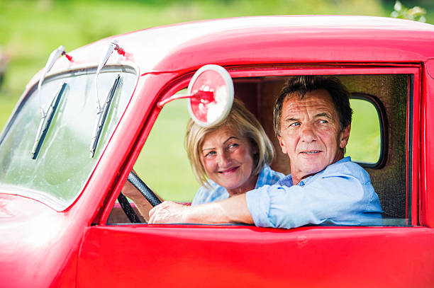 istock Senior couple in red car 504329798