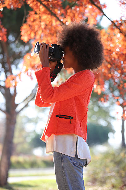 istock Young black lady trying her new camera for first time 504330264