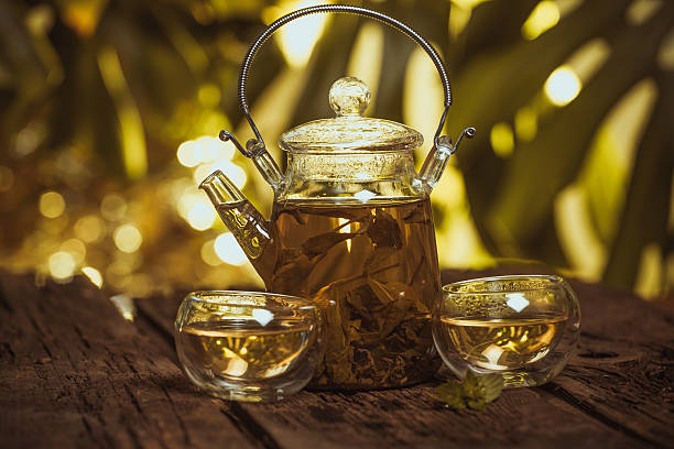istock Hot glass of tea on wood table 504332936