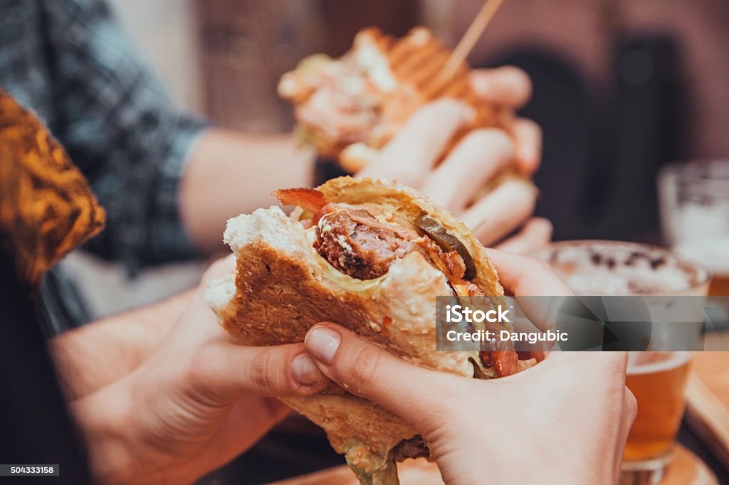 Female Eating Burger Close Up Of Womans Hands Holding Delicious Burger 20-29 Years Stock Photo