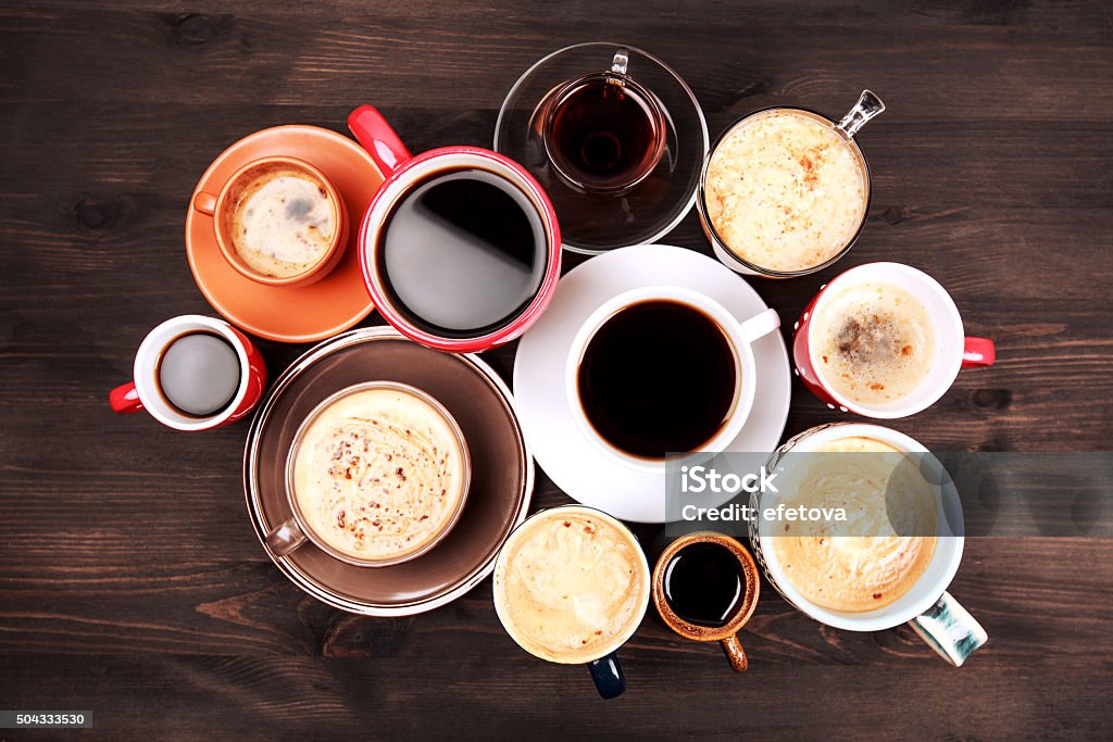 Many cups of coffee on wooden table Many different cups of coffee on dark wooden table, top view. Coffee - Drink Stock Photo