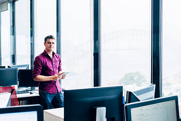 istock Portrait of man in modern office with computers 504334060
