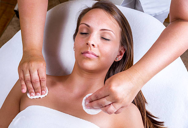 Beautician face cleaning. stock photo