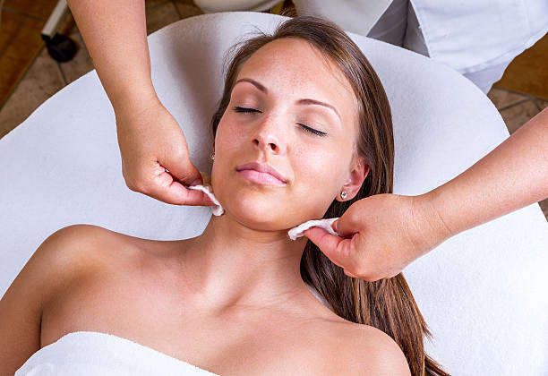 Beautician face cleaning. stock photo