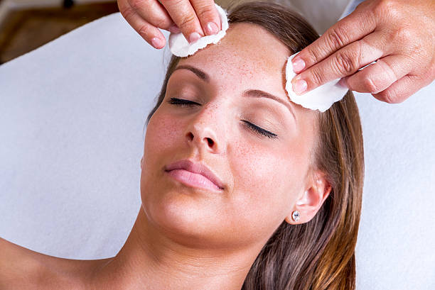 Beautician face cleaning. stock photo