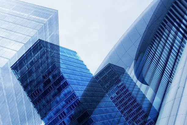 Tilt photo of contemporary architecture with structural glazing. Diagonal urban architectural composition of glazed aluminum structures in blue color.
