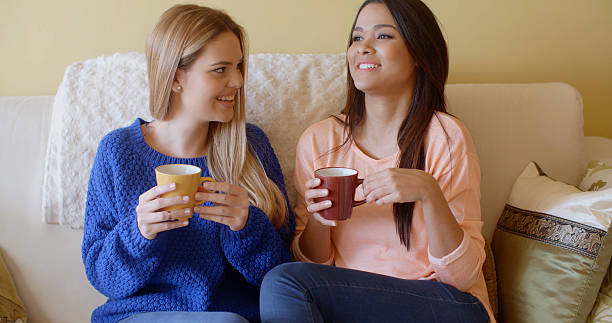 istock Two pretty young women enjoy a relaxing coffee 504335248