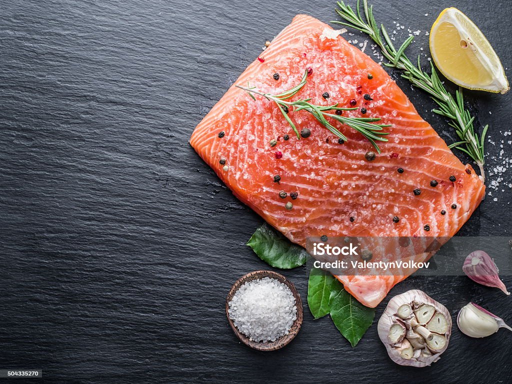 Fresh salmon on the cutting board. Fresh salmon on the cutting board. Cooking process. Salmon - Seafood Stock Photo