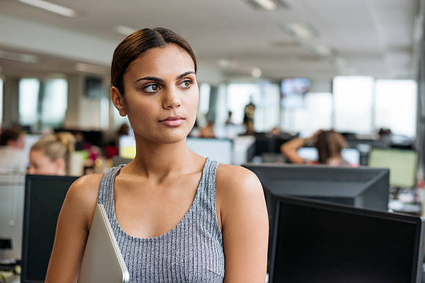 istock Businesswoman with tablet looking away in modern office 504335320
