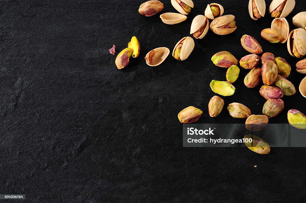 Pistaccio still-life pistachios over dark slate background Pistachio Stock Photo