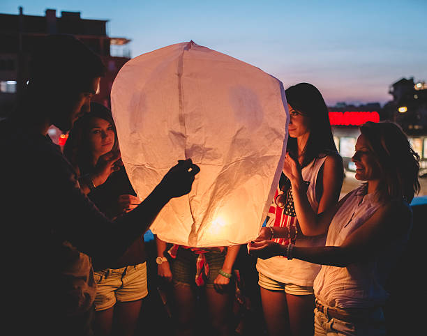 istock Friends releasing paper lantern 504337156