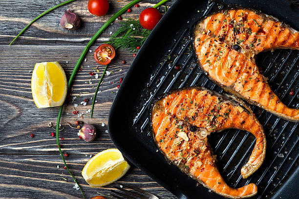 Grilled steaks salmon Grilled red fish steaks salmon on the grill pan grilled salmon stock pictures, royalty-free photos & images