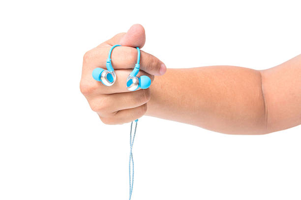 istock hand holding earphones isolated on white 504337928