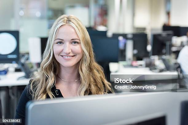 Businesswoman With Long Blond Hair Smiling Towards Camera Stock Photo - Download Image Now
