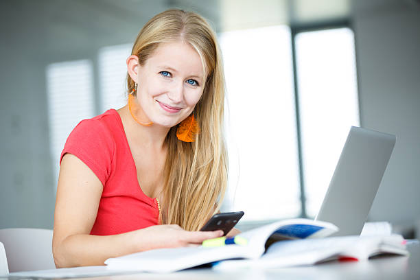 istock Pretty, female student in a high school library 504338341