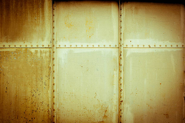istock Heavily rusted metal plate, with rusted, riveted edges 504339405
