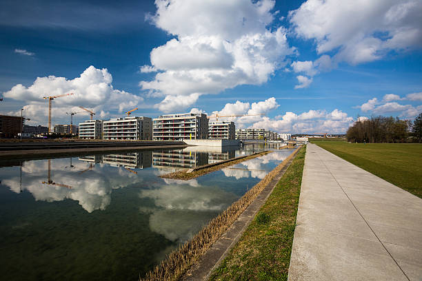 Modern residential housing project in a city by a lake or water reservoir on a lovely sunny day