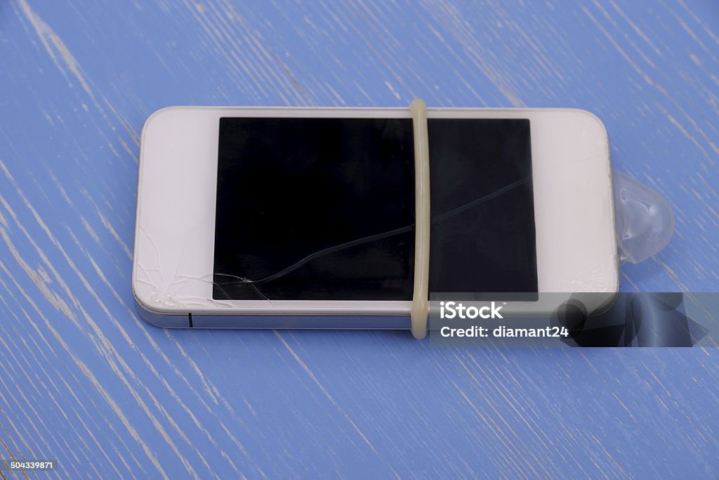 Smartphone with condoms protect against glass breakage Smartphone with condoms protect against glass breakage, concept Backgrounds Stock Photo