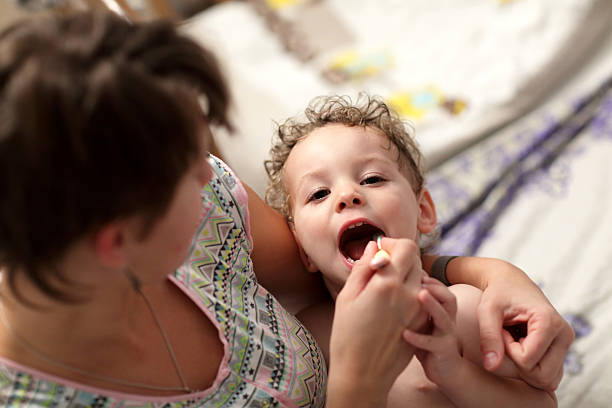 istock Mother brushes her toddler teeth 504340012