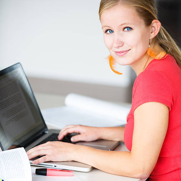 istock Pretty, female student in a high school library 504340375