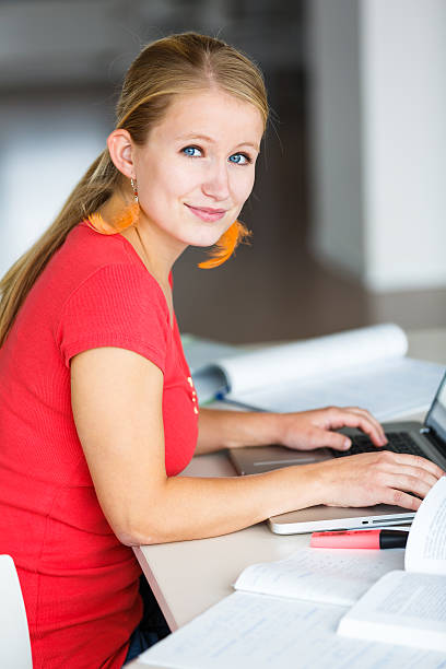 istock Pretty, female student in a high school library 504340379