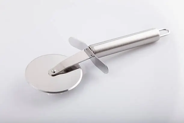 Stainless Metalic Pizza Cutter - Stock Image