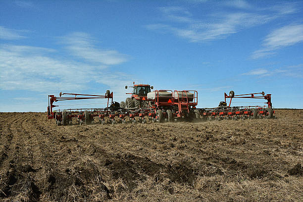 Working the Land Simultaneously planting, fertilizing and grooming a very large farm field apply fertilizer stock pictures, royalty-free photos & images