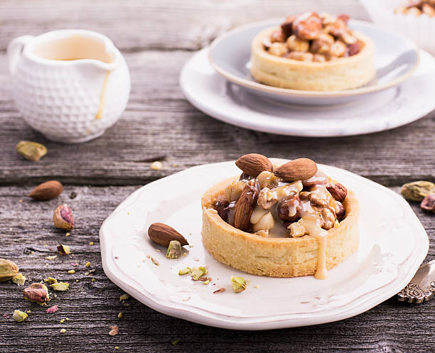 istock Tart with nuts and caramel on a rustic  background 504341110