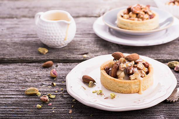 istock Tart with nuts and caramel on a rustic  background 504341130
