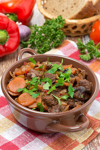 istock Stew with beef, vegetables and prunes in a saucepan, vertical 504341284