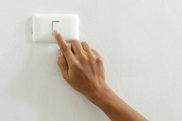 closeup of hand touch electric switch closeup of hand touch electric switch light switch photos stock pictures, royalty-free photos & images